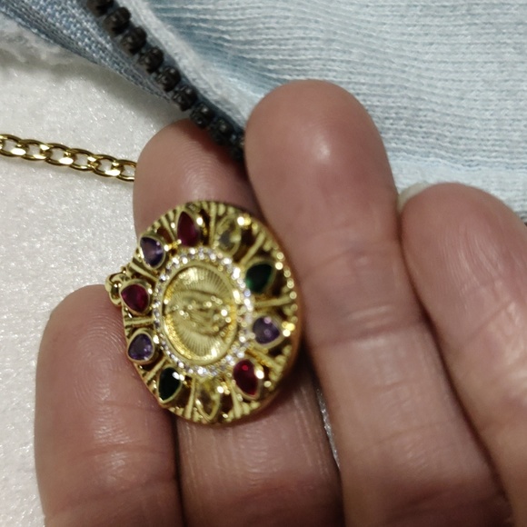 This necklace of the Virgin Mary is multi color and gold the chain is 23 inches - Picture 5 of 7